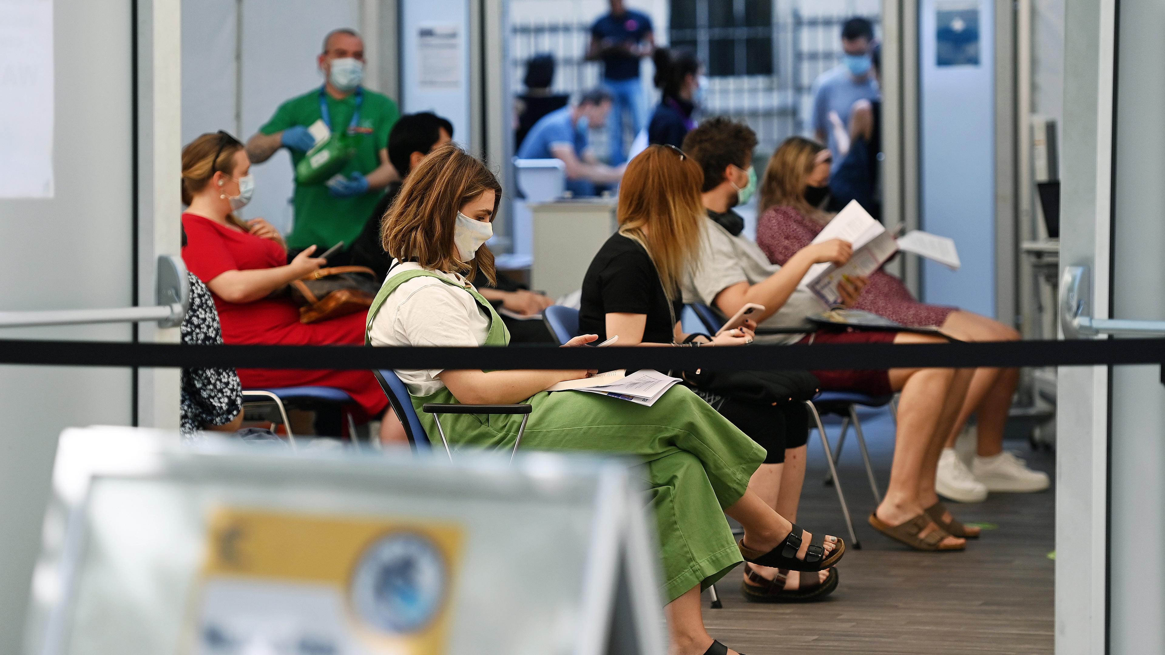 Menschen warten in Großbritannien im Impfzentrum auf ihre Impfung gegen das Coronavirus 