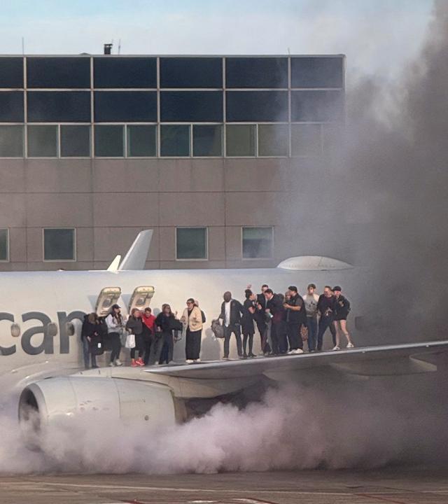 Menschen verlassen ein brennendes Flugzeug 