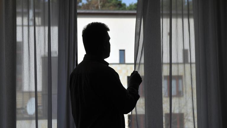 Ein Mann steht am Fenster seines Zimmers in der Oberbergklinik in Rietz, aufgenommen am 01.04.2011