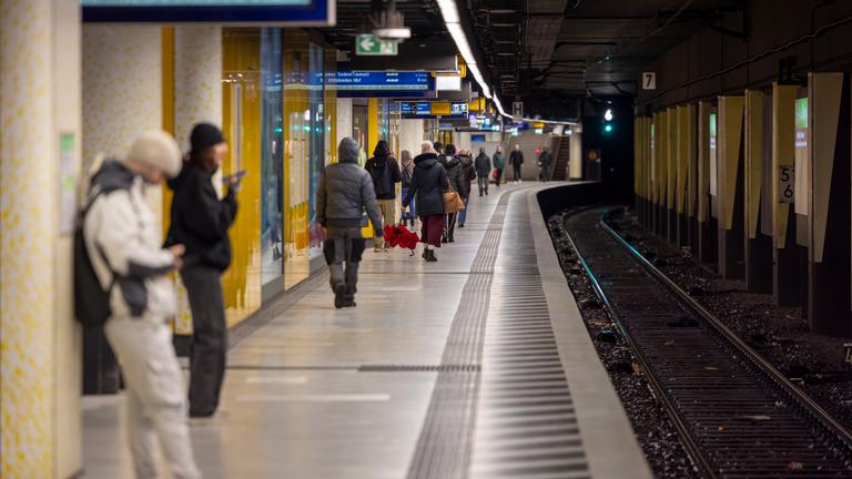 Menschen warten auf einem Bahnsteig
