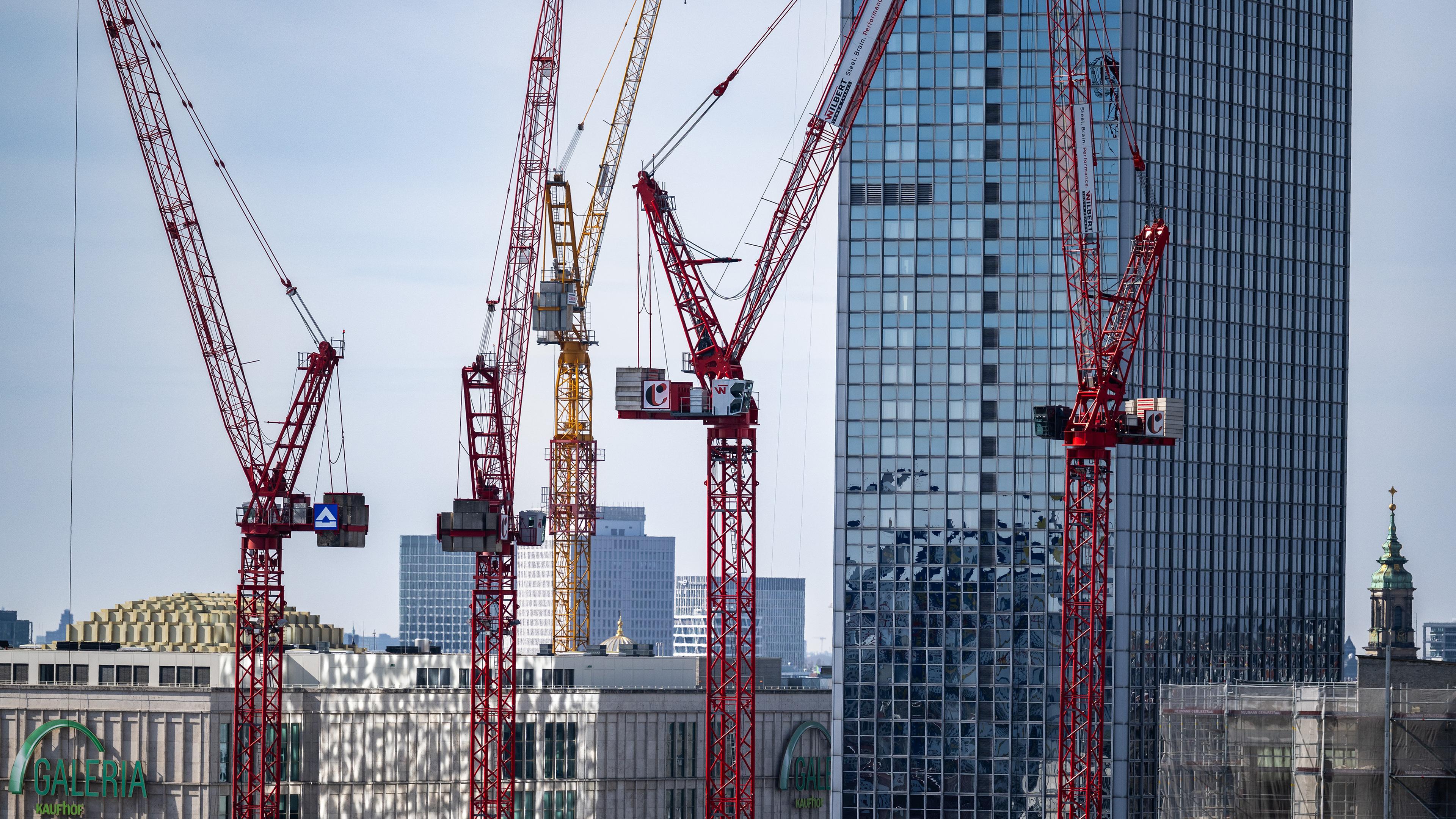 Kräne stehen auf einer Baustelle am Alexanderplatz in Berlin (Symbolbild für die deutsche Wirtschaft).