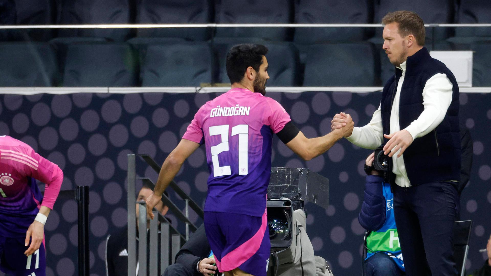 Abklatschen zwischen Fußball-Bundestrainer Nagelsmann und Kapitän Gündogan bei dessen Auswechslung