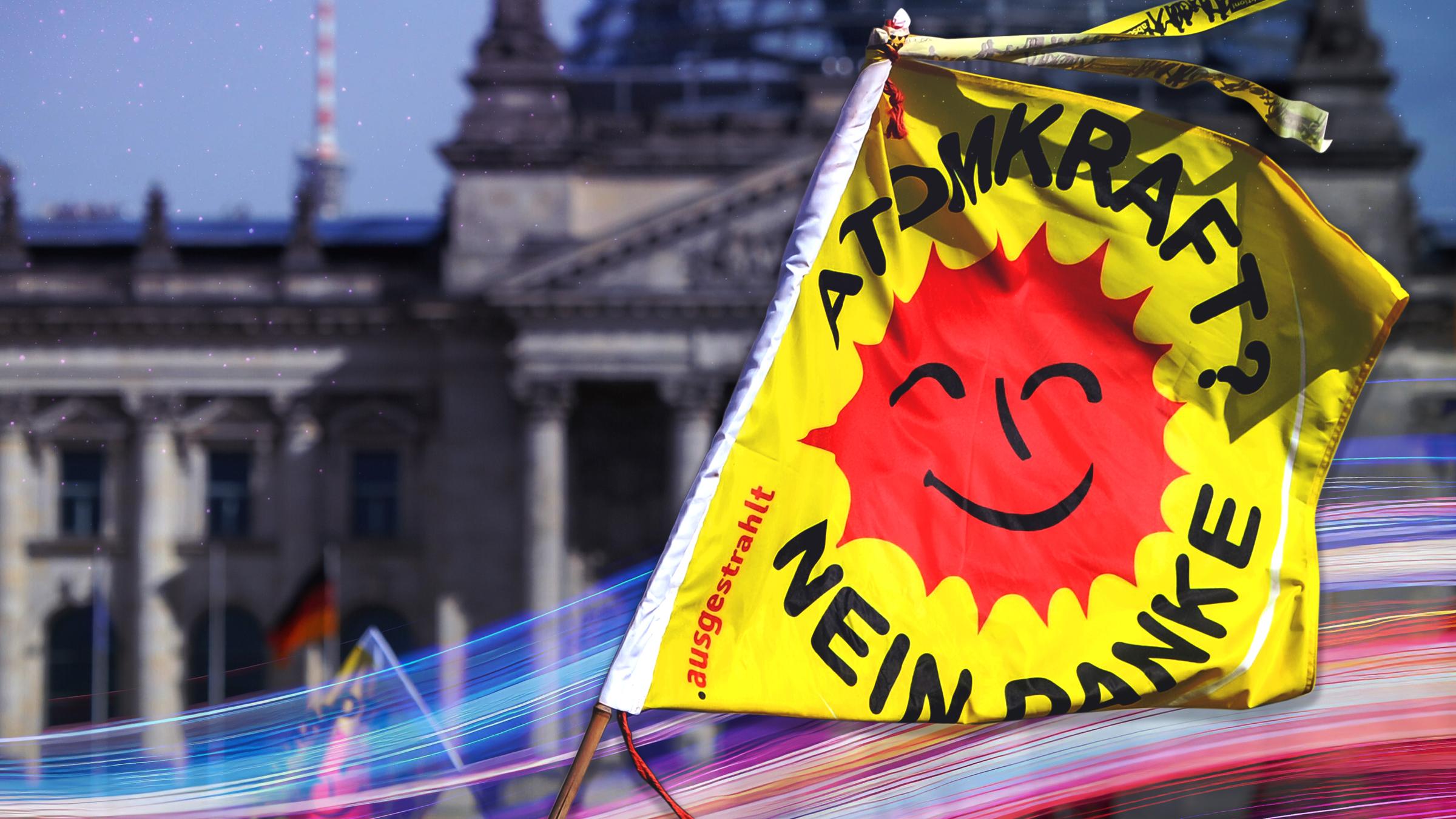Montage: Vor dem Reichstaggebäude in Berlins liegt die Abbildung einer Flagge mit der Aufschrift "Atomkraft? Nein danke".