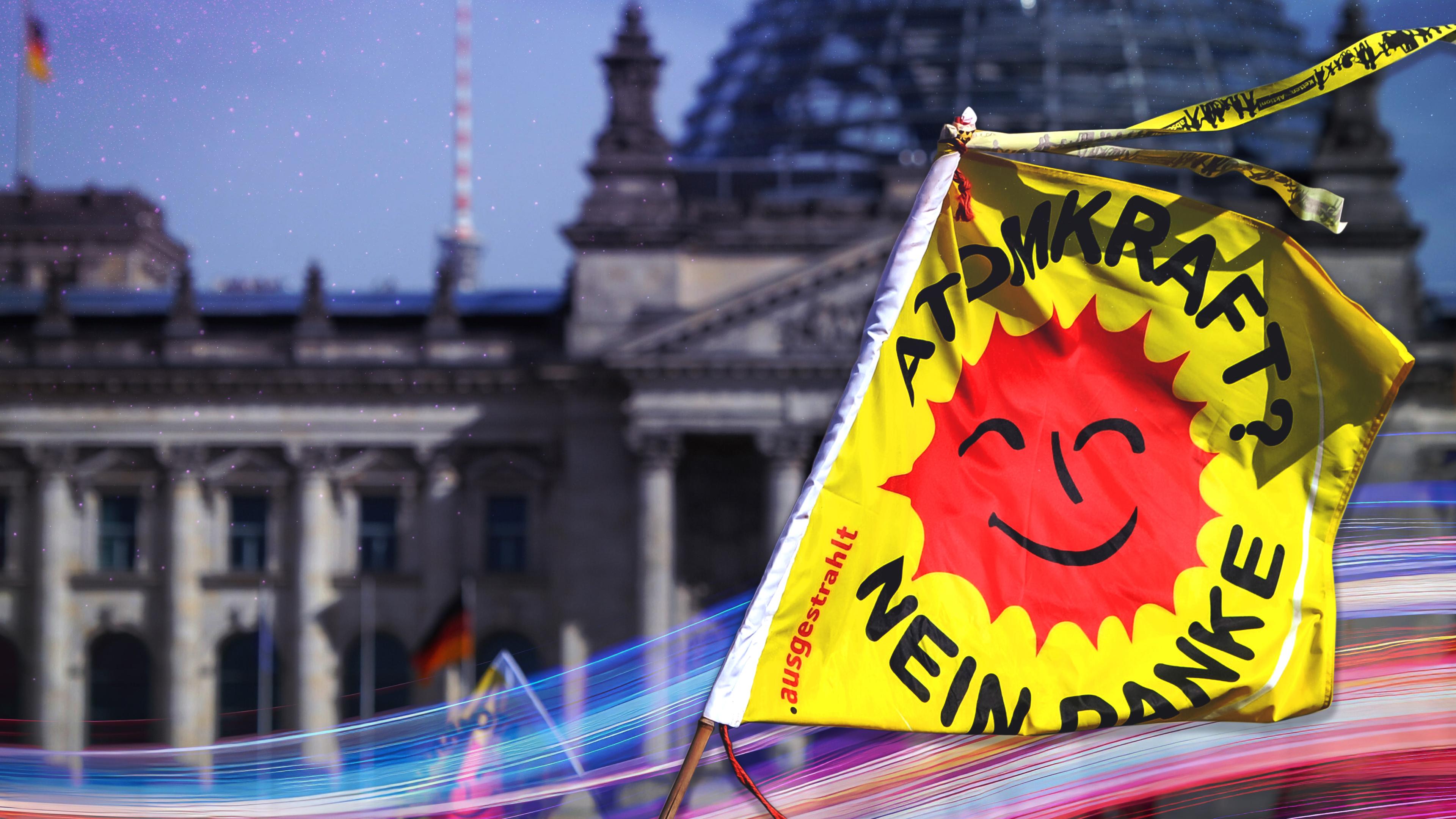 Montage: Vor dem Reichstaggebäude in Berlins liegt die Abbildung einer Flagge mit der Aufschrift "Atomkraft? Nein danke".