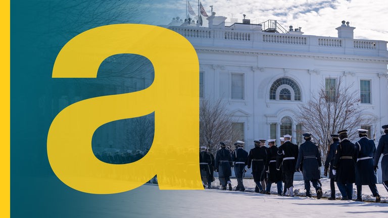Eine Reihe Soldaten marschieren vor dem weißen Haus, im Hintergrund eine Flagge der USA