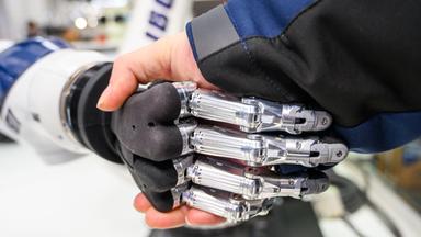 Eine Hand schüttelt eine Roboterhand