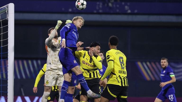 Dinamo Zagrebs Verteidiger (Nr. 06) Maxime Bernauer (C) kämpft mit Borussia Dortmunds Verteidiger (Nr. 05) Rami Bensebaini (2.v.r.) und Borussia Dortmunds Torhüter (Nr. 01) Gregory Kobel (L) um den Ball.