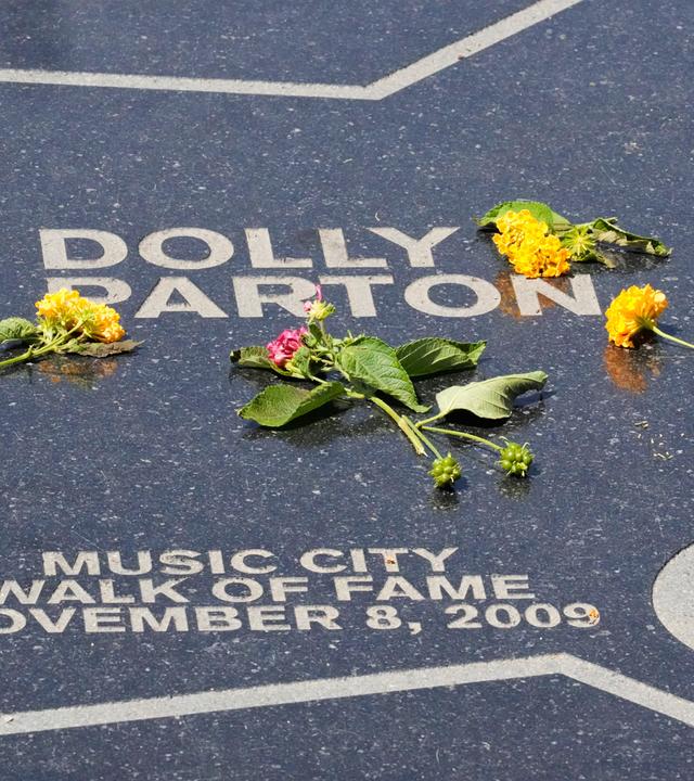 Flowers are placed on Dolly Parton's star at Walk of Fame Park on Tuesday, Aug. 25, 2026, in Nashville.