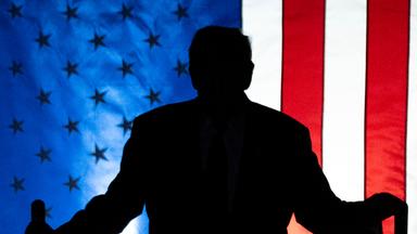 Archiv: Schatten von Donald Trump vor US-Flagge