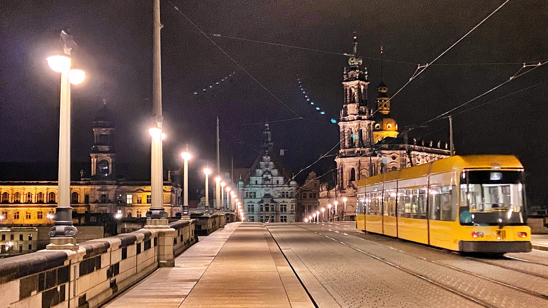 Eine Straßenbahn fährt über die Augusustbrücke in Dresden.