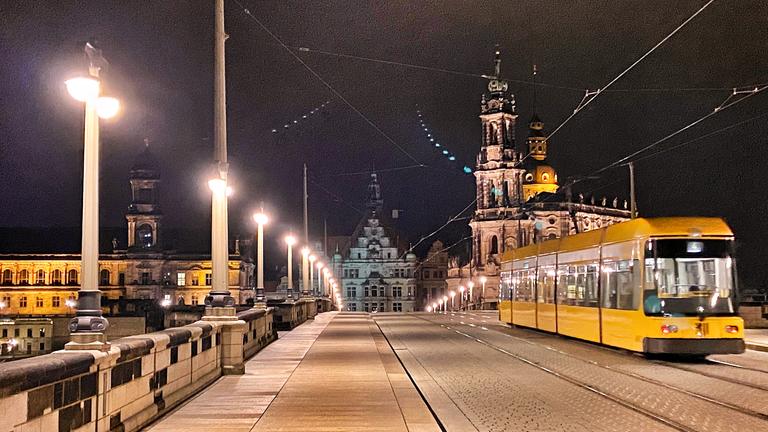 Eine Straßenbahn fährt über die Augusustbrücke in Dresden.