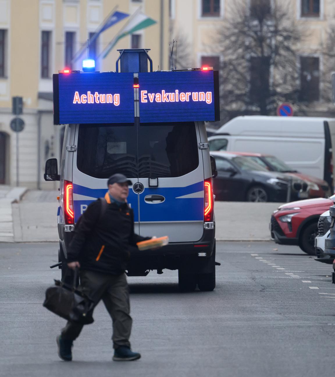 Ein Polizeiwagen fährt während einer Evakuierung der Innenstadt durch die Straßen, um Bürger zu informieren. 