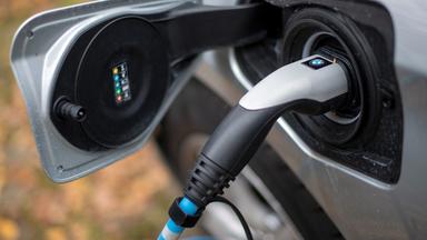 Ein Elektrofahrzeug von BMW lädt an einer Ladesäule