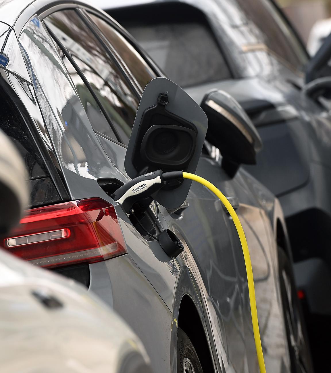 Mehrere E-Autos stehen hintereinander in einer Reihe.