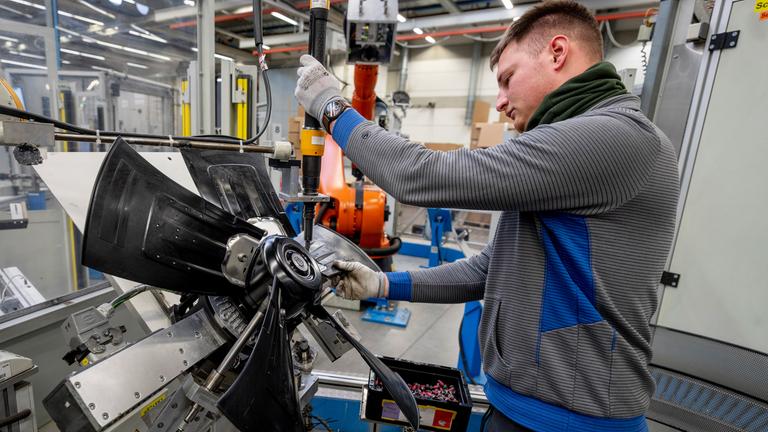 Ein Mann arbeitet am Dienstag, den 4. Februar 2025, an Ventilatoren in einem EBM-Papst-Werk in Hollenbach