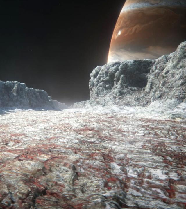 Computeranimiertes Bild einer breiten Schlucht in eisiger Landschaft, im Hintergrund ein großer Himmelskörper, dessen Oberfläche mit verschiedenfarbigen Streifen bedeckt ist.
