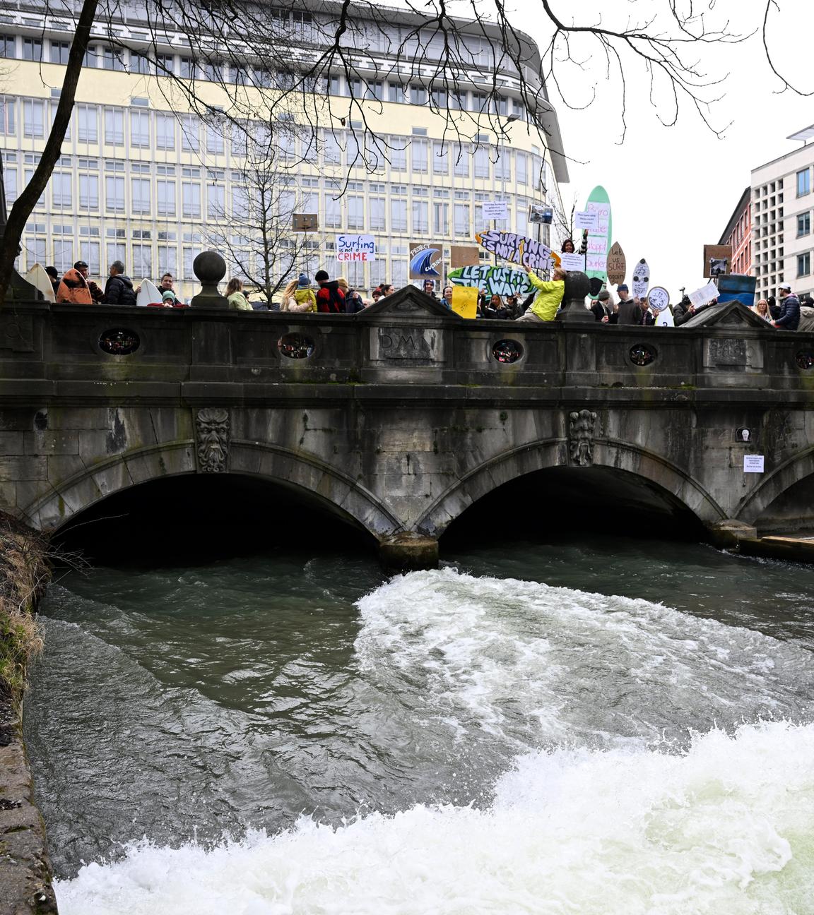 Teilnehmer nehmen an der Demonstration gegen das Surfverbot an der Eisbachwelle teil.