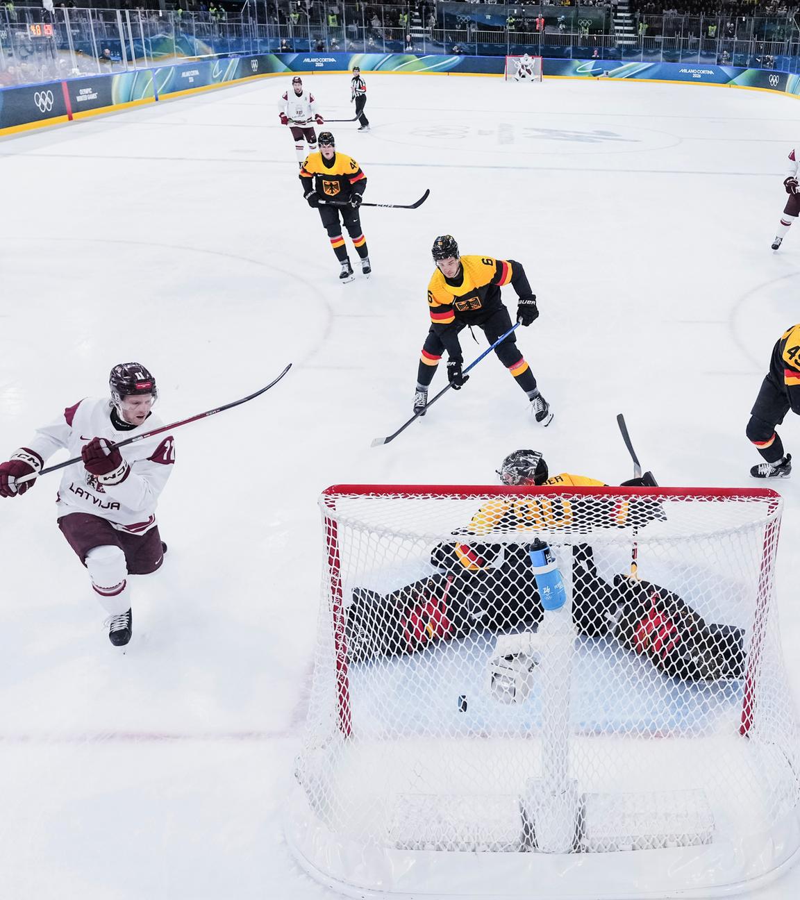 Der lettische Eishockeyspieler Dans Ločmelis erzielt bei den Olympischen Winterspielen 2026 in der Partie gegen Deutschland ein Tor