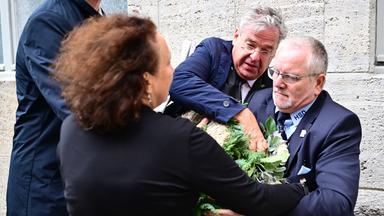 Auf dem Bild sieht man Tobias Korenke, der Großneffen von Dietrich und Klaus Bonhoeffer, wie er den Kranz der AfD zertstört. Das Sicherheitspersonal neben ihm, versucht ihm den Kranz abzunehmen.