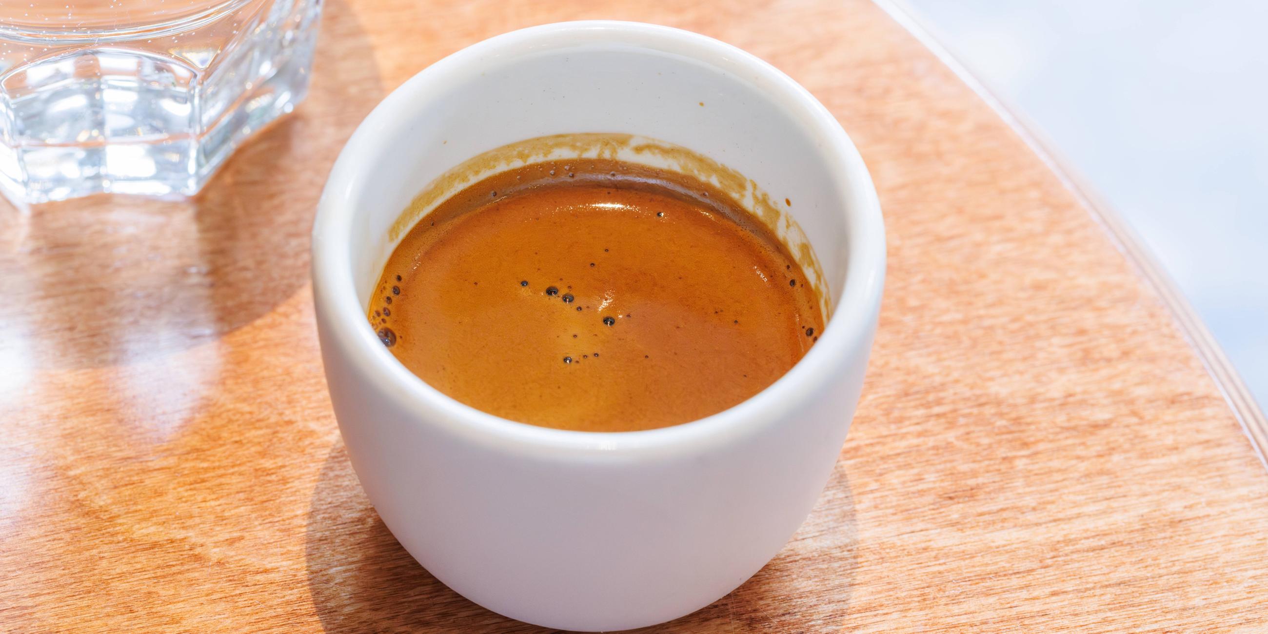 Frisch gebrühter Espresso in einer kleinen Tasse auf einem Tisch serviert