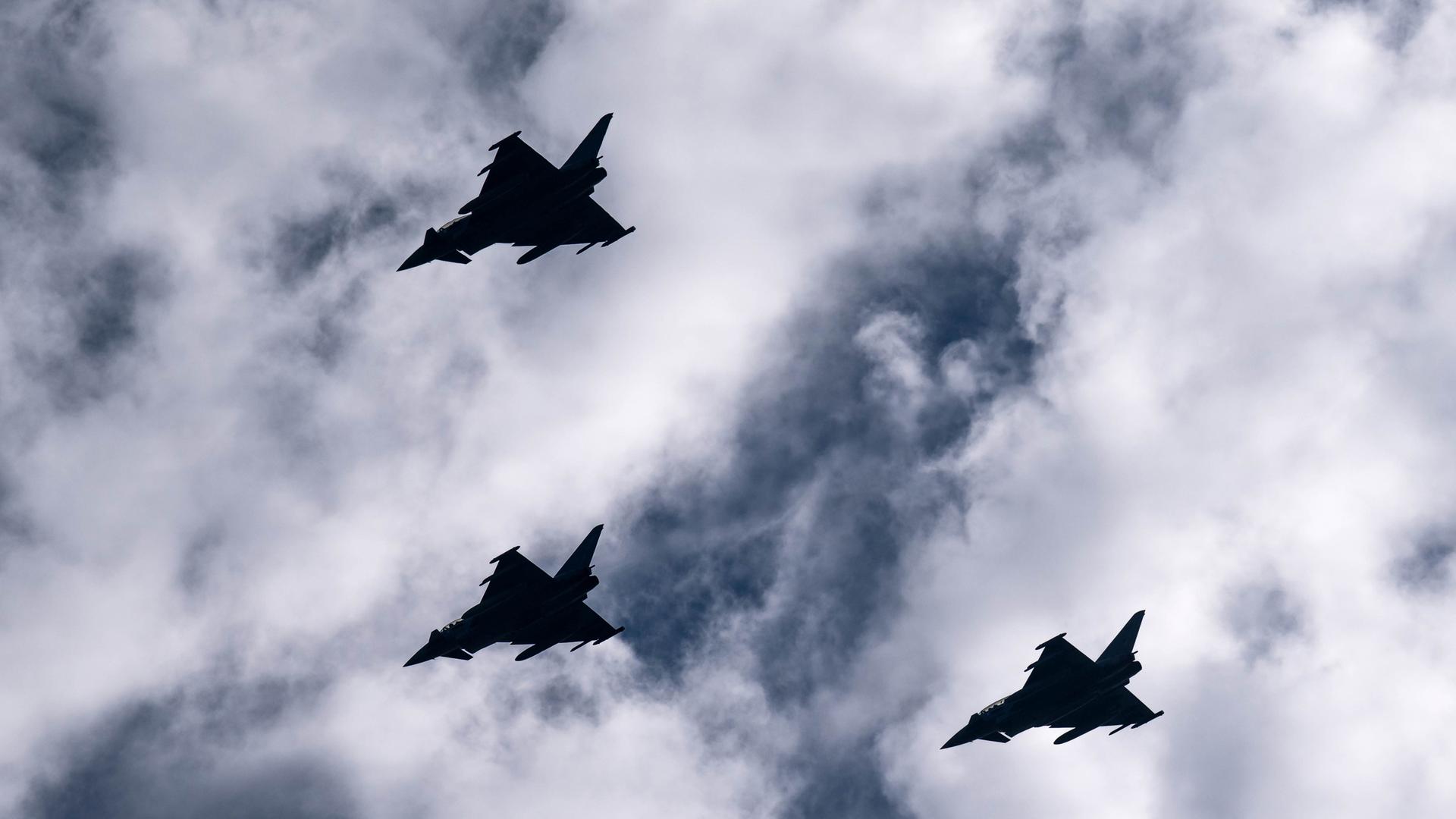 Eurofighter fliegen bei der Ankunft der "Baden-Württemberg" über den Hafen.