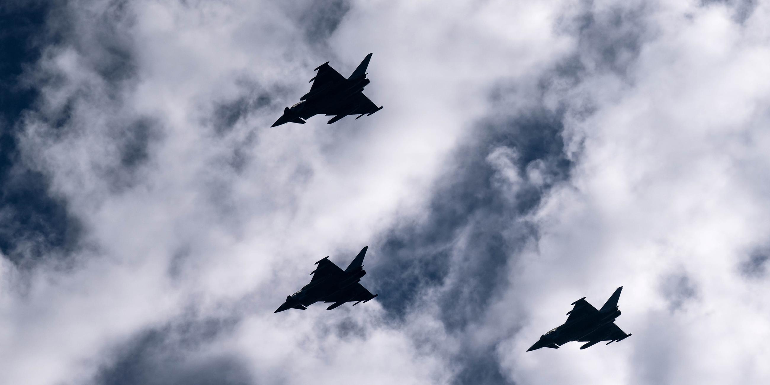 Eurofighter fliegen bei der Ankunft der "Baden-Württemberg" über den Hafen.