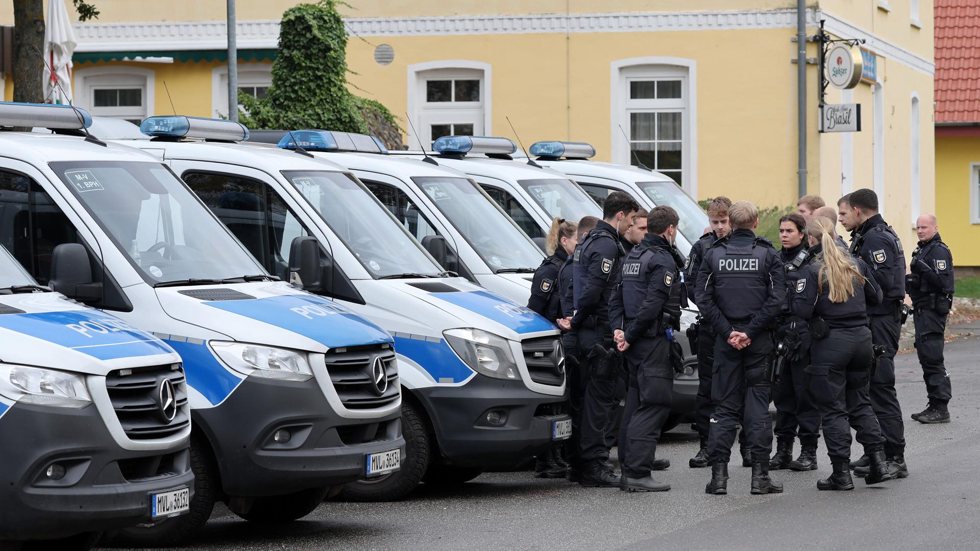 Polizisten sammeln sich im Ortszentrum von Klein Upahl, wo in einem Waldstück in der Nähe am Vortag eine Kinderleiche gefunden wurde.