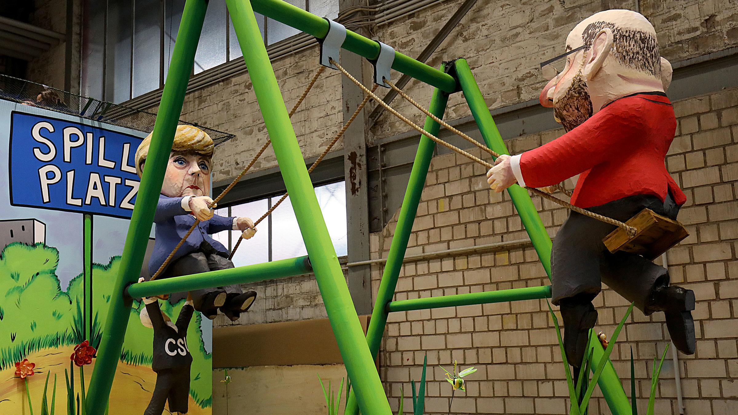 Angela Merkel und Martin Schulz auf der GroKo-Schaukel.