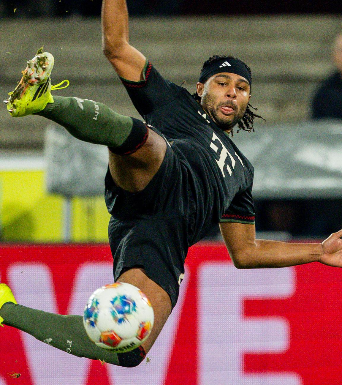 Serge Gnabry (FC Bayern) erzielt den Ausgleich zum 1:1 gegen Marvin Schwäbe (1. FC Köln), während Jan Thielmann (1. FC Köln) beteiligt ist. 1. FC Köln – Bayern München.