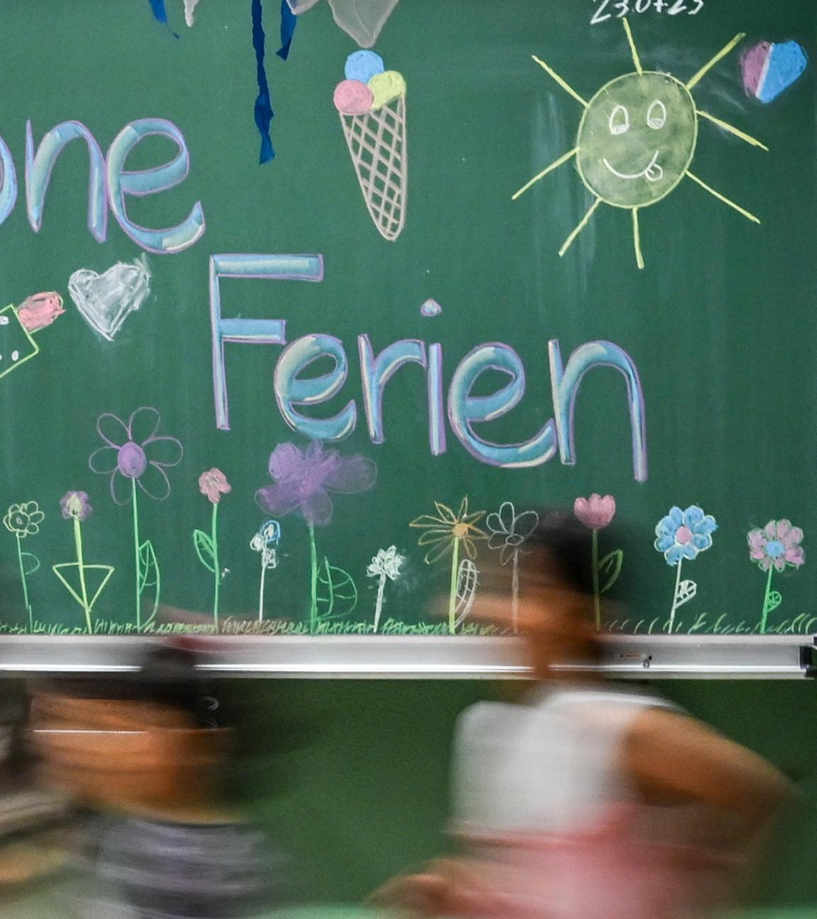 "Schöne Ferien" steht auf einer bunt bemalten Tafel in der Schule in der Köllnischen Heide – ein fröhlicher Gruß zum letzten Schultag vor den Sommerferien. Aufgenommen am 23.07.2025 in Berlin.
