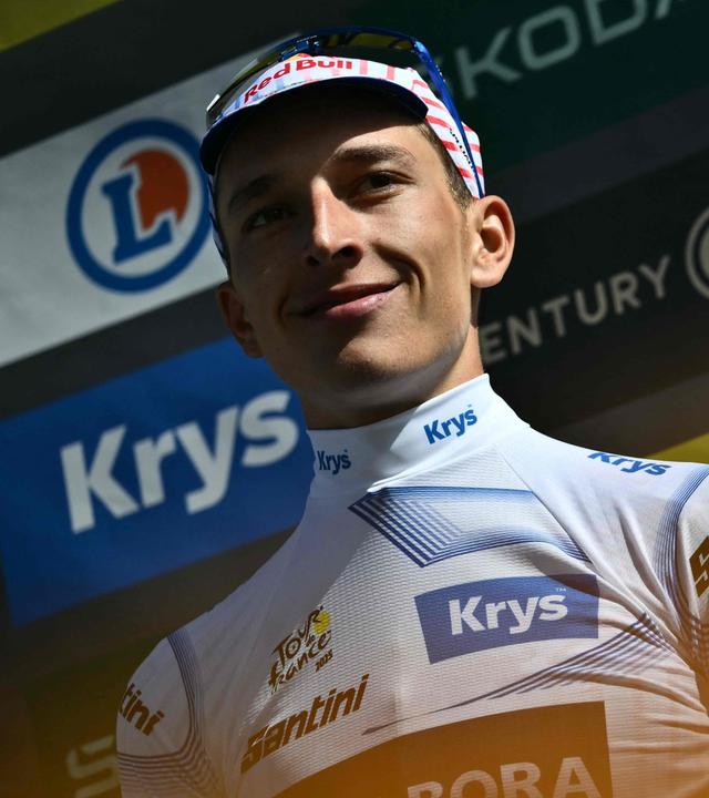 Der Deutsche Florian Lipowitz, der das Weiße Trikot des besten Nachwuchsfahrers trägt, feiert auf dem Podium.