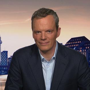 ZDF-Wirtschaftskorrespondent Florian Neuhann vor einem Foto der Berliner Skyline