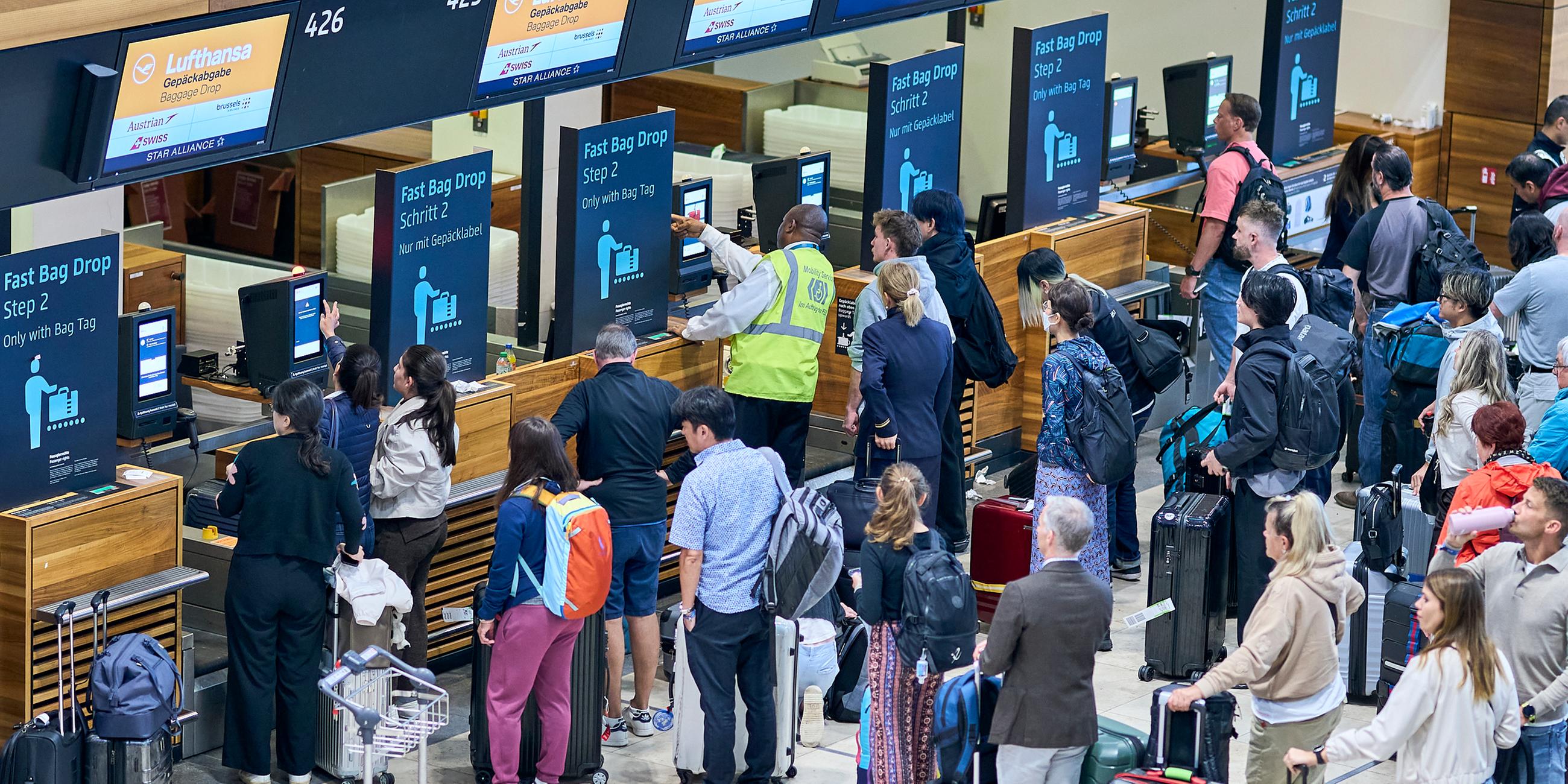 Brandenburg, Schönefeld: Zahlreiche Fluggäste warten vor den Check-in-Schaltern im Terminal 1 des Flughafens Berlin Brandenburg.