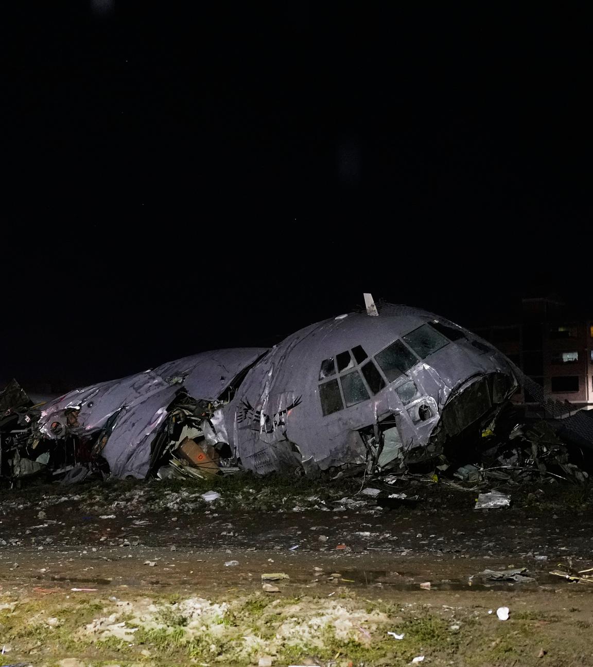 Polizeibeamte stehen neben dem Wrack eines abgestürzten Militärflugzeugs in Bolivien.