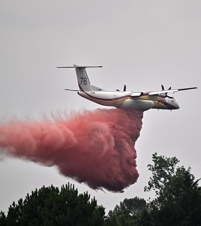 Frankreich: Marcheprime: ein Löschflugzeug wirft über den Bränden in der Region Bordeaux Löschmittel ab. 