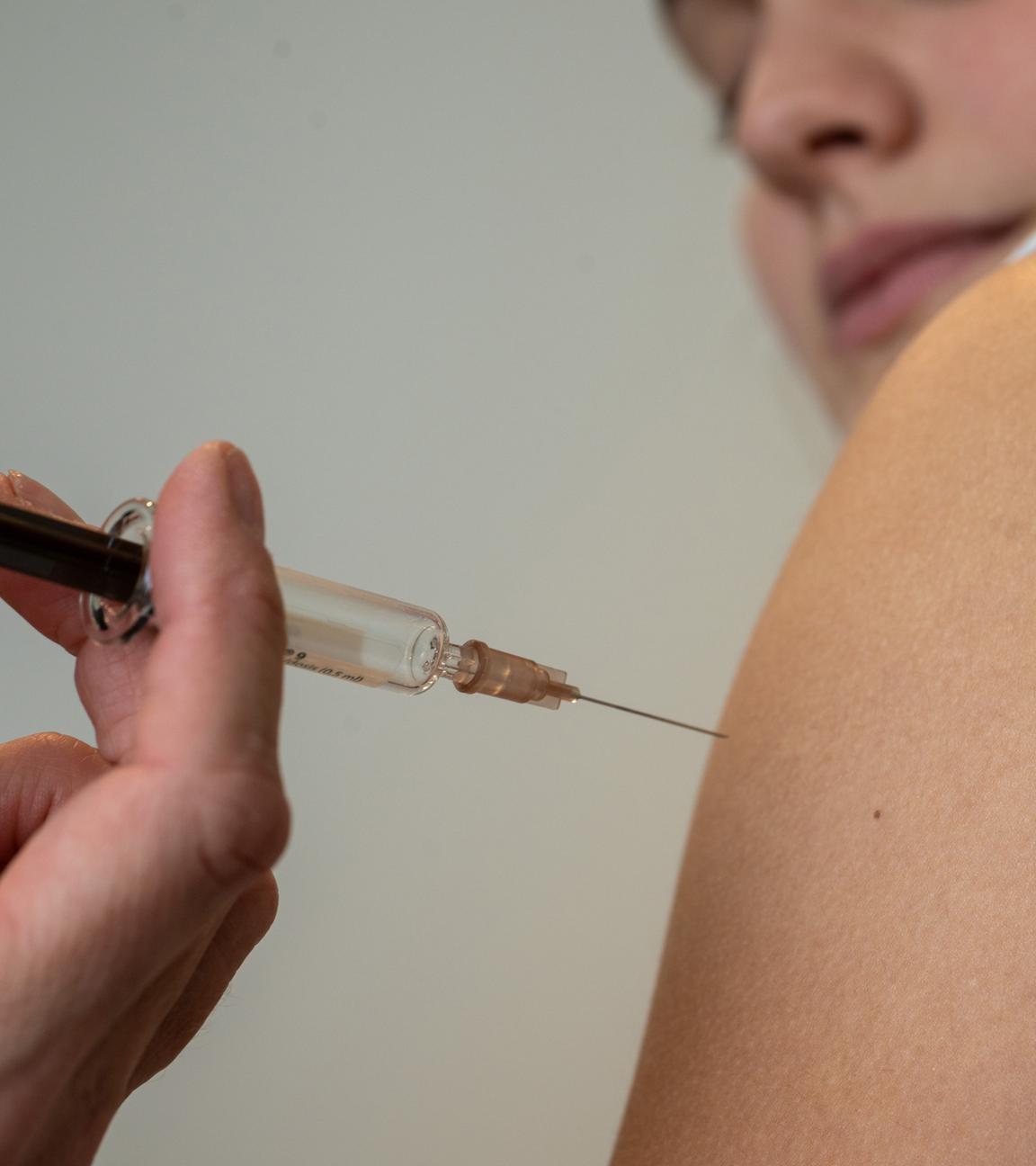 Bayern, Planegg: Gynäkologin setzt bei der HPV-Impfung in einer Frauenarztpraxis eine Injektion in den Oberarm einer Jugendlichen.