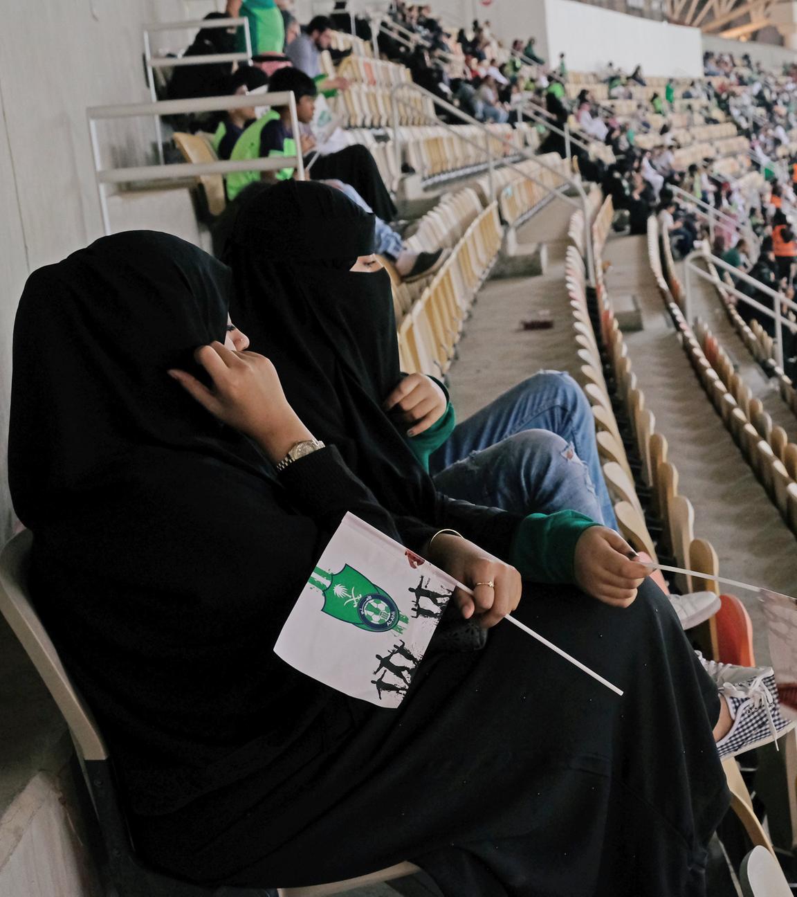 saudi women watch the soccer match between al-ahli against al-batin at the king abdullah sports city in jeddah