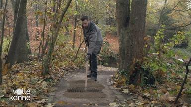 Mann arbeitet an Waldweg
