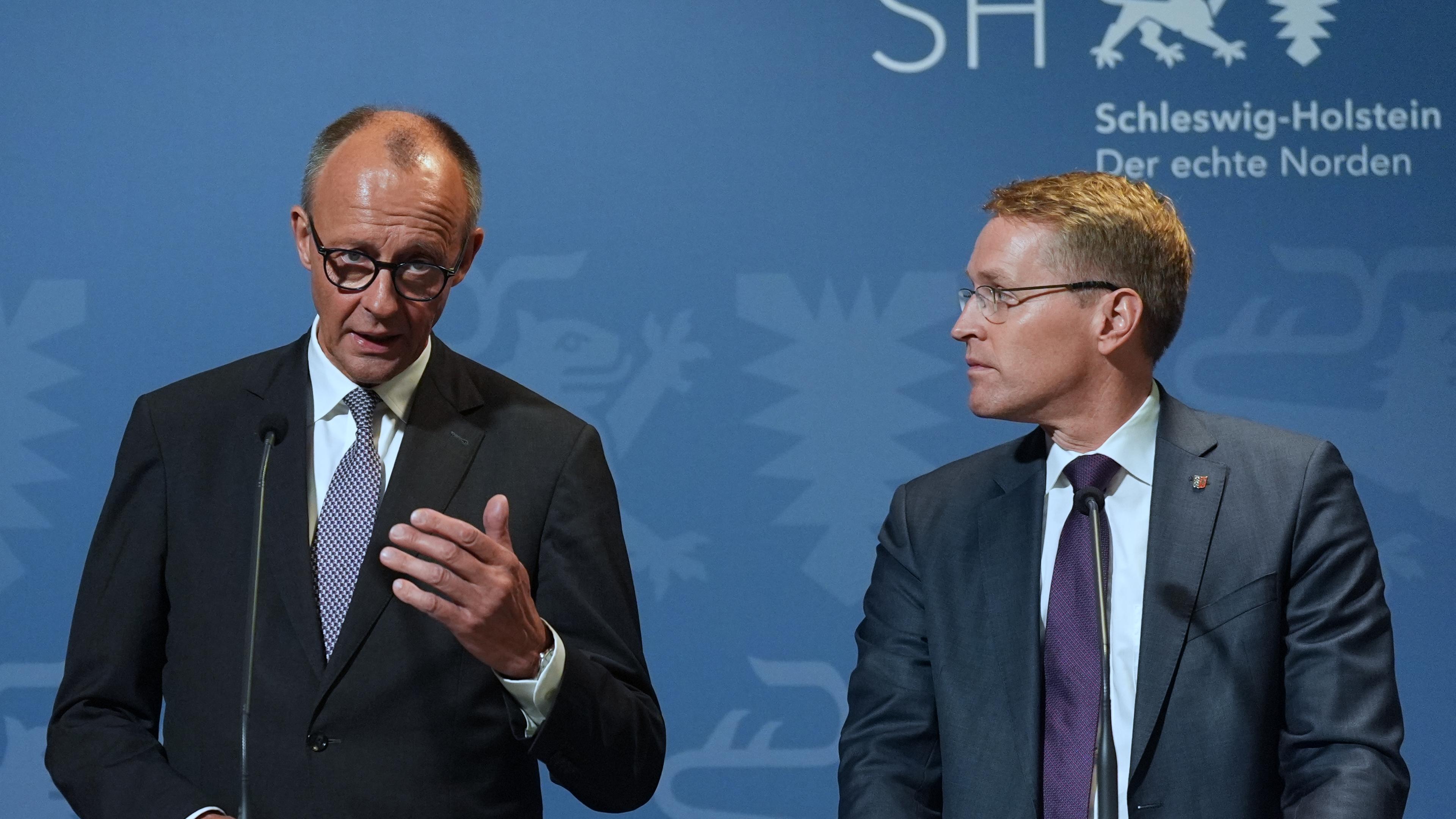 Bundeskanzler Friedrich Merz (l, CDU) und Daniel Günther (CDU), Ministerpräsident von Schleswig-Holstein, stehen während einer Pressekonferenz im Schifffahrtsmuseum Nordfriesland.