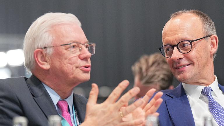 Roland Koch (l, CDU), ehemaliger Ministerpräsident von Hessen spricht mit Friedrich Merz auf dem CDU-Parteitag im Februart 2025. (Archiv)