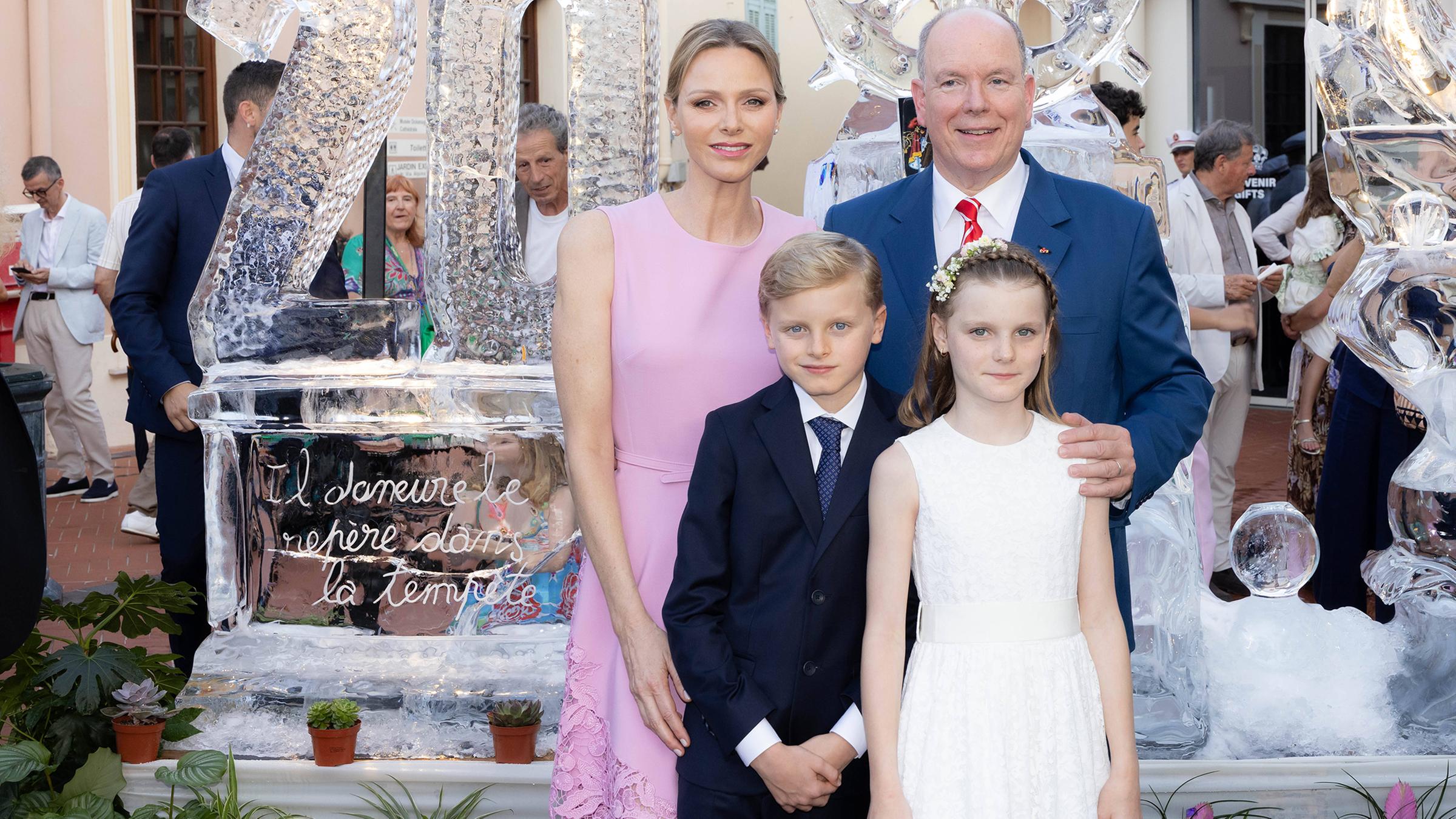 Fürst Albert von Monaco mit seiner Frau und seinen zwei Kindern vor einer prachtvollen Eisskulptur. 