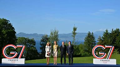 France's President Emmanuel Macron (R) and his wife Brigitte Macron (L) pose with Canada's Prime Minister Mark Carney (C-R) and his wife Diana Fox Carney during the official greeting as part of the G7 summit, in Evian, eastern France, on June 15, 2026. A G7 summit is set to take place June 15 to 17 in the French town of Evian-les-Bains near Switzerland and it will be attended by country leaders as well as the EU's foreign policy chief and ministers from Brazil, Canada, the United Arab Emirates and Turkey. 
