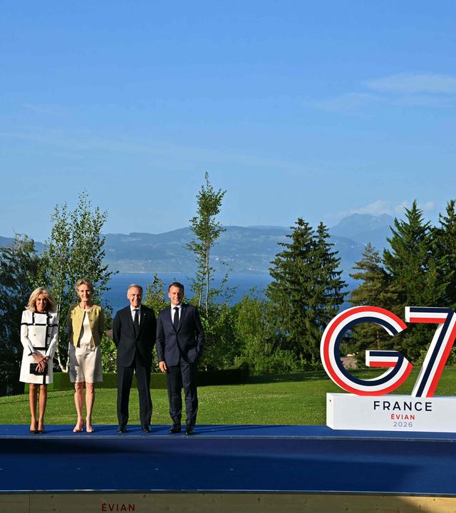 France's President Emmanuel Macron (R) and his wife Brigitte Macron (L) pose with Canada's Prime Minister Mark Carney (C-R) and his wife Diana Fox Carney during the official greeting as part of the G7 summit, in Evian, eastern France, on June 15, 2026. A G7 summit is set to take place June 15 to 17 in the French town of Evian-les-Bains near Switzerland and it will be attended by country leaders as well as the EU's foreign policy chief and ministers from Brazil, Canada, the United Arab Emirates and Turkey. 