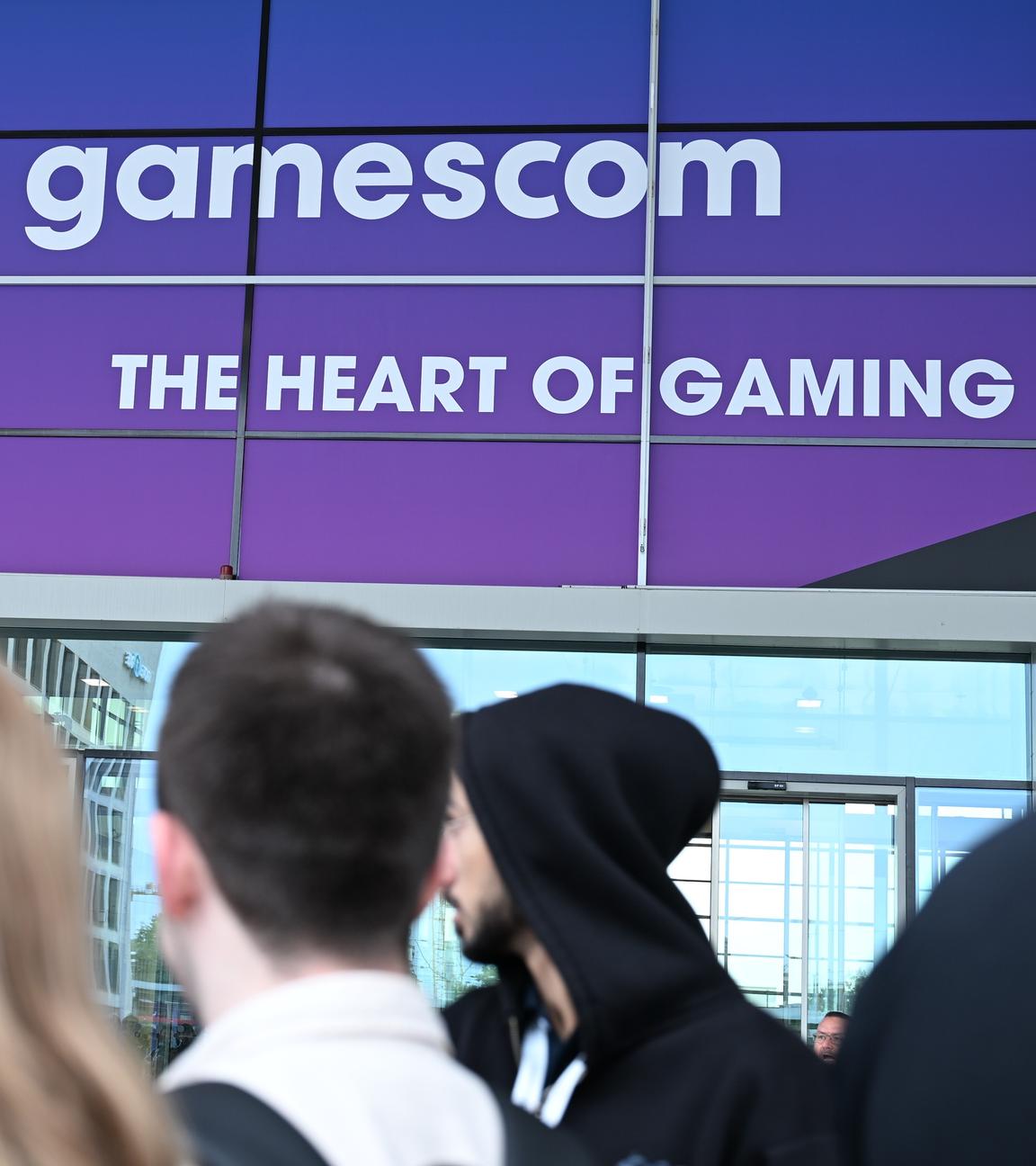 Zu sehen sind mehrere Menschen, die vor dem Gamescom-Gebäude stehen