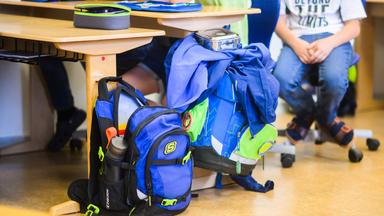 Schüler sitzen neben ihren Schulranzen im Klassenraum einer 4. Klasse in der Grundschule.