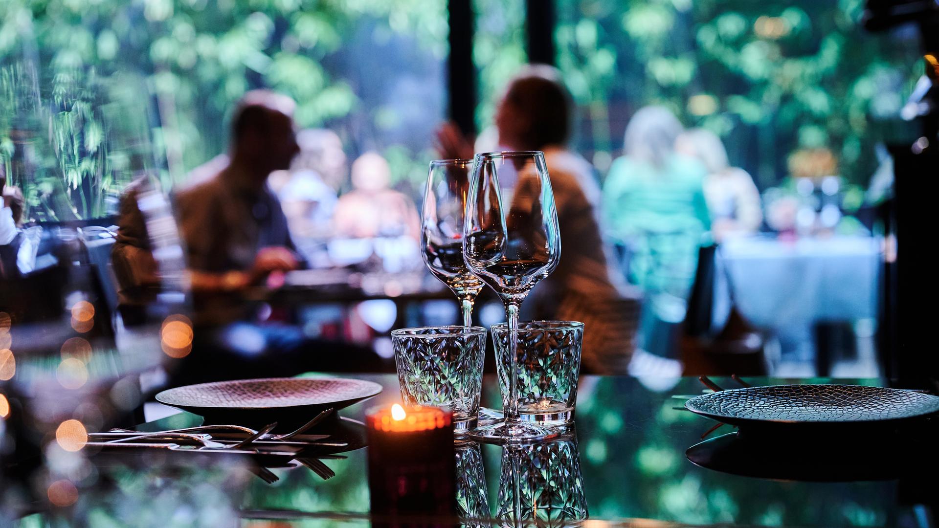 Symbolbild: Gäste sitzen innen und außen in einem Restaurant.