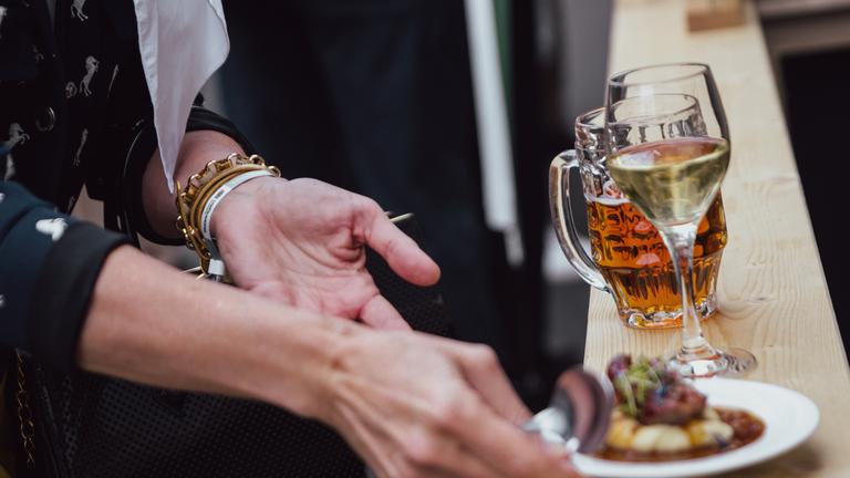 Symbolbild: Eine Besucherin hält Thüringer Spezialitäten in der Hand