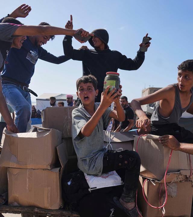 Palestinians carry boxes containing food and humanitarian aid packages delivered by the Gaza Humanitarian Foundation, a U.S.-backed organization approved by Israel, in Rafah, southern Gaza Strip, on Tuesday, May 27, 2025.