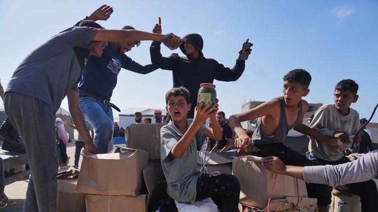 Palestinians carry boxes containing food and humanitarian aid packages delivered by the Gaza Humanitarian Foundation, a U.S.-backed organization approved by Israel, in Rafah, southern Gaza Strip, on Tuesday, May 27, 2025.