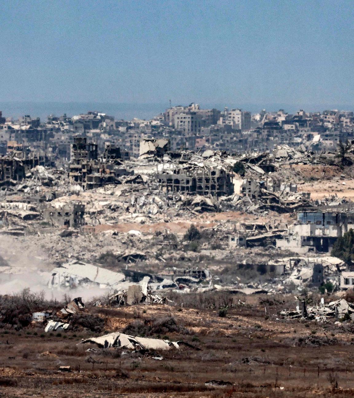Destroying buildings in the Gaza Strip are pictured from a position along Israel's southern border with the besieged Palestinian territory on August 5, 2025.